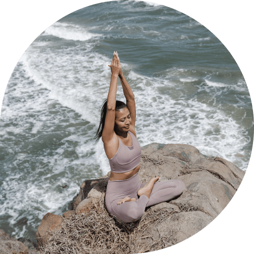 full-shot-woman-yoga-pose-seaside